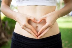 close-up-female-hands-shaping-heart-belly_1262-3467